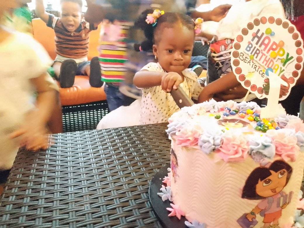 Baby girl cutting birthday cake
